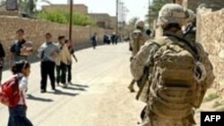 U.S. Marines are pictured here with Iraqi schoolchildren in Haditha. 