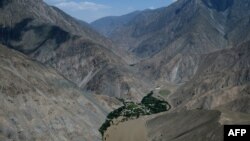Mud from a landslide caused by flooding Baghlan province in June 9, 2014.