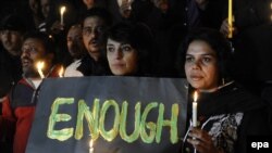 Pakistani journalists light candles to pray for the victims who were killed in an attack at the Army run school in Peshawar, during a memorial ceremony in Islamabad on December 16.