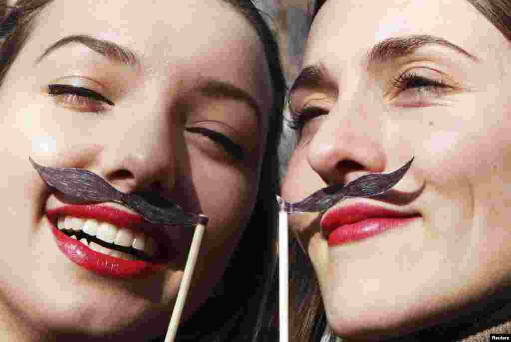 Two Kosovar Albanians pose with paper moustaches during an event marking the Albanian declaration of independence in Pristina on November 28. The moustaches are intended to honor some of the signees of the declaration, many of whom sported such moustaches. (Reuters/Hazir Reka)