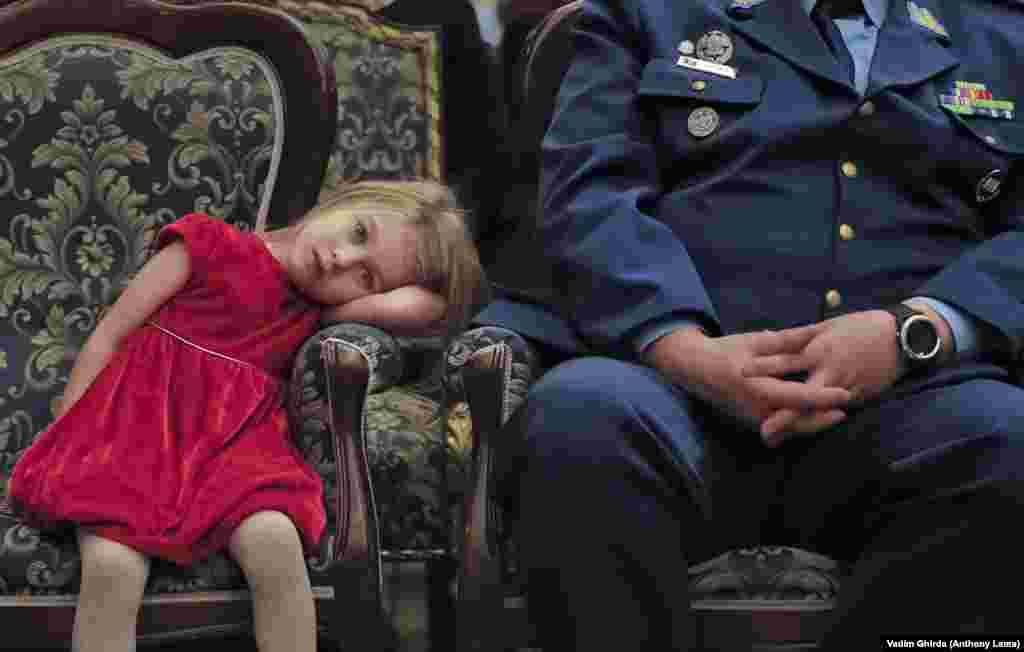 A girl pauses during a Christmas show for children of Romanian military families in Bucharest on December 21. (AP/Vadim Ghirda)