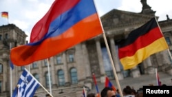 GERMANY-- Supporters hold Armenian, German and Greek flags during approval of a resolution by Germany's parliament that declares the 1915 massacre of Armenians by Ottoman forces a genocide.