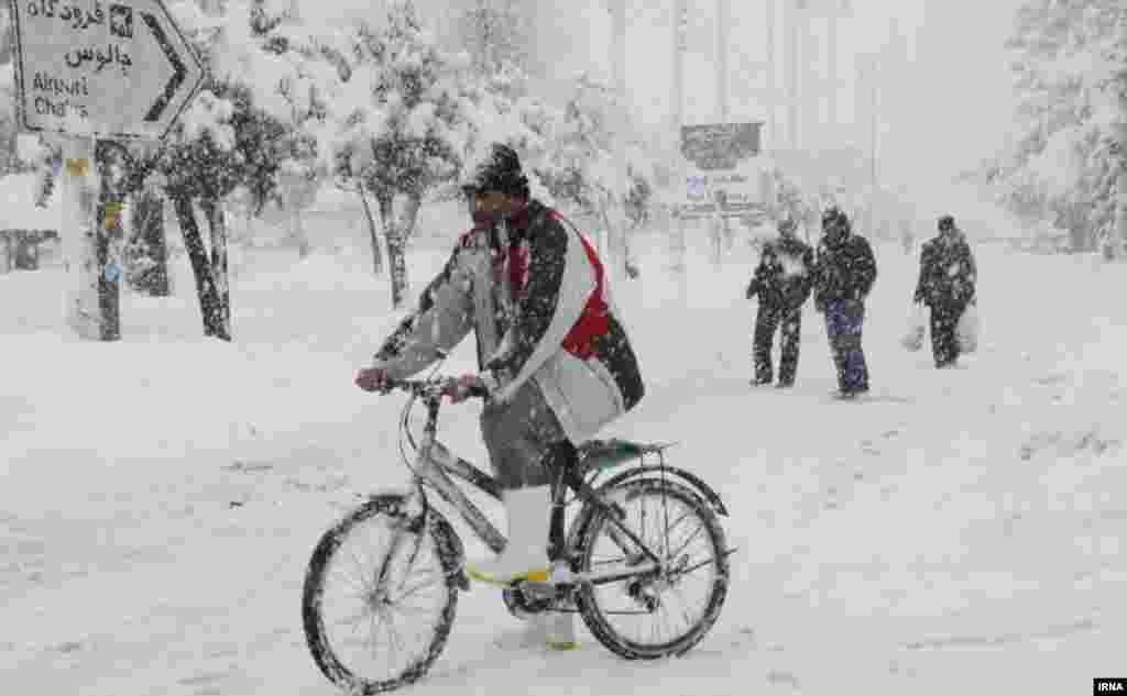 In Iran's Mazandaran Province, a bicyclist tries his luck on a snowy road.