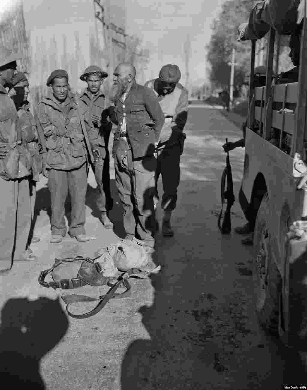 As the maharajah wavered, violent uprisings broke out and tribal militants sent from Pakistan infiltrated the region in a bid to seize it by force. This rare photo shows one of the Pathan fighters, swaddled in looted clothing, after his capture by Indian troops.