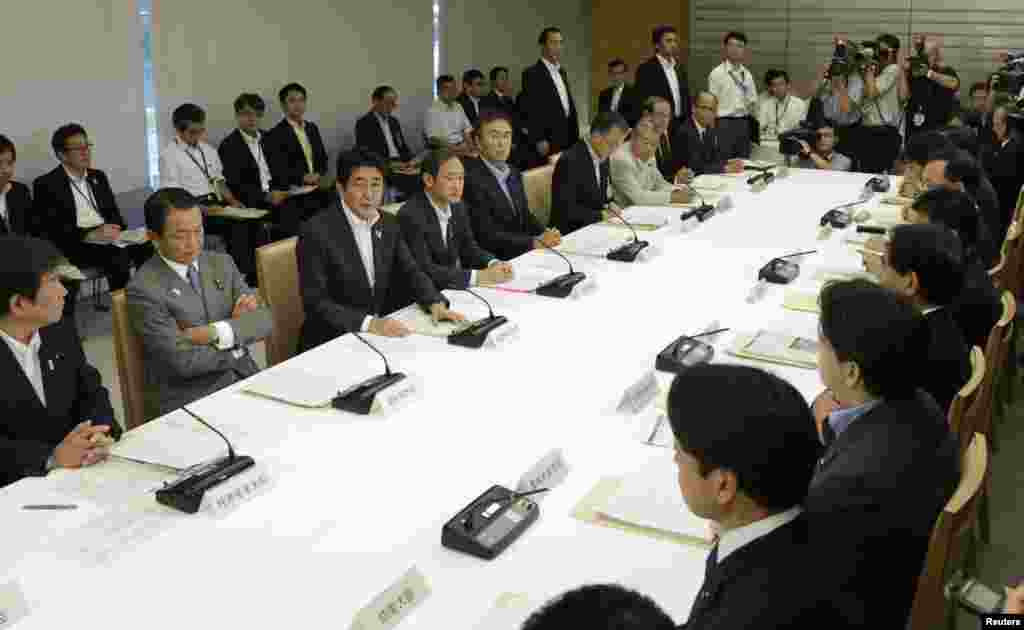 Japanese Prime Minister Shinzo Abe (third from left) speaks during a meeting with nuclear authorities on September 3.