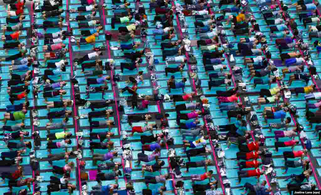 People participate in Solstice In Times Square: Mind Over Madness Yoga, an all-day yoga event in Times Square in New York City to mark the summer solstice on June 21. (epa/Justin Lane)