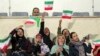 IRAN -- Iranian women cheer during the friendly football match between Iran and Bolivia at the Azadi Stadium in Tehran, October 16, 2018