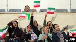 IRAN -- Iranian women cheer during the friendly football match between Iran and Bolivia at the Azadi Stadium in Tehran, October 16, 2018