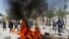 Afghanistan -- Afghan protesters set a fire during a protest in Kabul, Afghanistan June 2, 2017. 