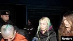 Ukrainian Femen activists Aleksandra Nemchinova, Inna Shevchenko, and Oksana Shachko (left to right) speak to reporters at a hospital in the Belarusian town of Elsk on December 20.