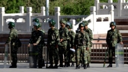 China -- Chinese paramilitary policemen stand guard on a city square in Urumqi in China's Xinjiang region on May 24, 2014. China has seen a series of incidents in recent months targeting civilians, sometimes far from Xinjiang itself, which authorities ha