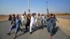 Afghans shout slogans against the government after a military operation reportedly left many civilians dead in the Rodat district of Nangarhar Province on October 24.