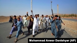 Afghans shout slogans against the government after a military operation reportedly left many civilians dead in the Rodat district of Nangarhar Province on October 24.