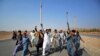 Afghans shout slogans against the government after a military operation reportedly left many civilians dead in the Rodat district of Nangarhar Province on October 24.