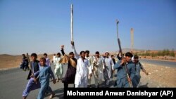 Afghans shout slogans against the government after a military operation reportedly left many civilians dead in the Rodat district of Nangarhar Province on October 24.