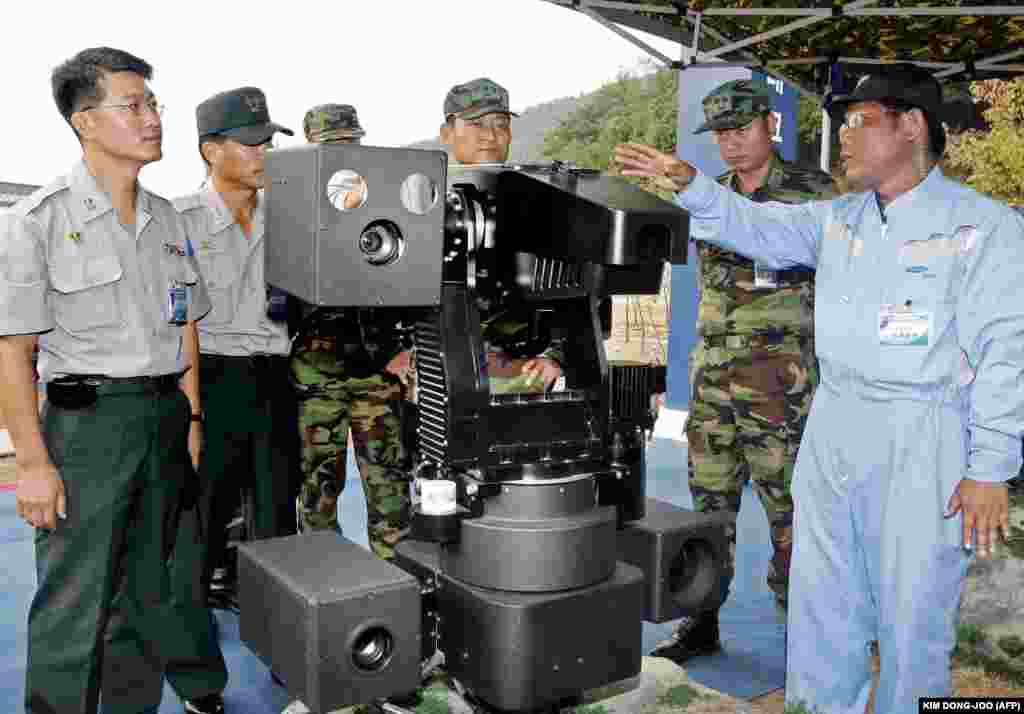 The SGR-A1s can spot suspicious movement from up to 4 kilometers away. Once an alarm is sounded, a human operator can give the command to open up with a machine gun (concealed under its weather shelter at top right) or pop 40-millimeter grenades at its target. The system sparked significant hand-wringing over the ethics of bringing lethal weaponry to the brink of autonomy.