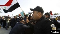 Police clash with protesters during a demonstration against Syrian President Bashar al-Assad outside the "Friends of Syria" conference in Tunis on February 24.