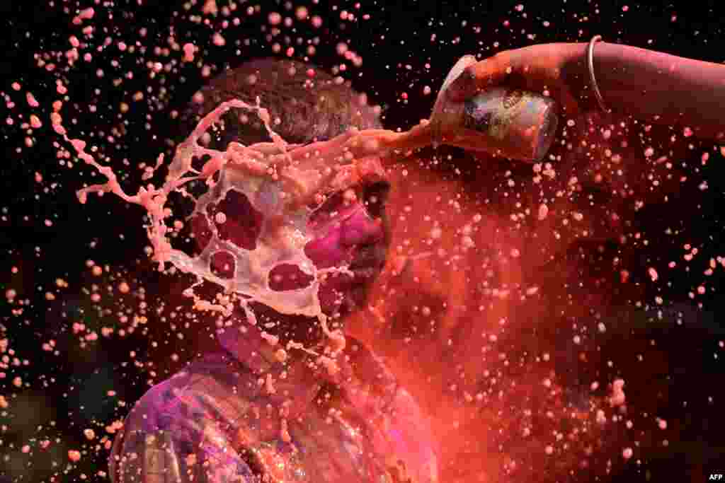 An Indian boy is doused with colored water during Holi festival celebrations in Chennai. Holi, the popular Hindu spring festival of colors, is observed in India at the end of the winter season on the last full moon of the lunar month, and will be celebrated on March 2 this year. (AFP/Arun Sankar)