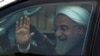 Iranian President Hassan Rohani waves to onlookers after his arrival at Begumpet Airport in Hyderabad, India, on February 15.