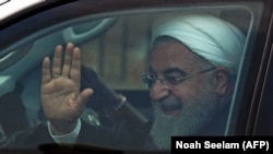 Iranian President Hassan Rohani waves to onlookers after his arrival at Begumpet Airport in Hyderabad, India, on February 15.