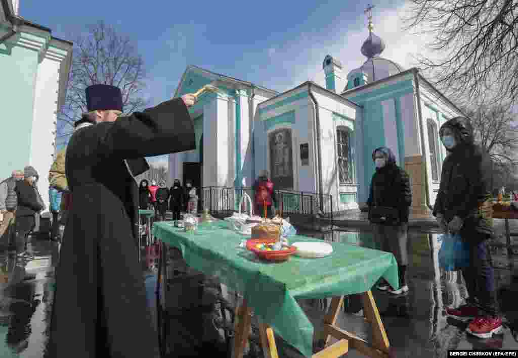 A Russian priest blesses food on the eve of Orthodox Easter Sunday in Moscow.