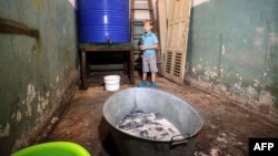 Ten-year-old Sasha stands in a bomb shelter in Donetsk in eastern Ukraine.