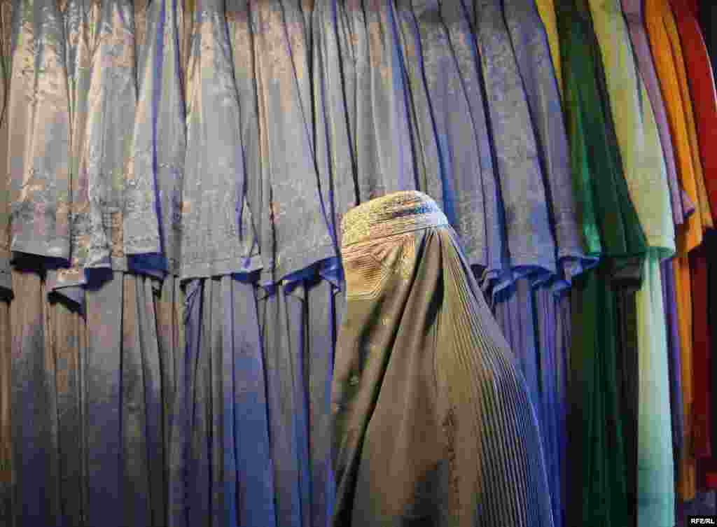 An Afghan woman browses at the burqa market in Kabul. - Photo by RFE/RL