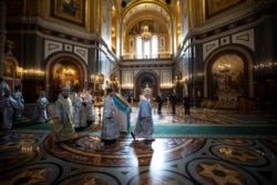 Russian Orthodox Church Patriarch Kirill (center) walks to conduct a religious service on the eve of Orthodox Easter during a live broadcast from an almost-empty cathedral in Moscow on April 17.