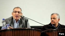 Professor Sadegh Zibakalam (left) speaks as former legislator Ahmad Shirzad looks on at a conference about Iran's nuclear program at Tehran University on December 17.