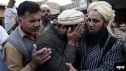 Relatives of one of the victims killed in a suicide attack on a National Database and Registration Authority (Nadra) office, react outside a hospital in Mardan, Pakistan on December 29. 