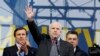 U.S. Senator John McCain (center) waves to pro-European-intergration protesters during a mass rally at Independence Square in Kyiv on December 15. 