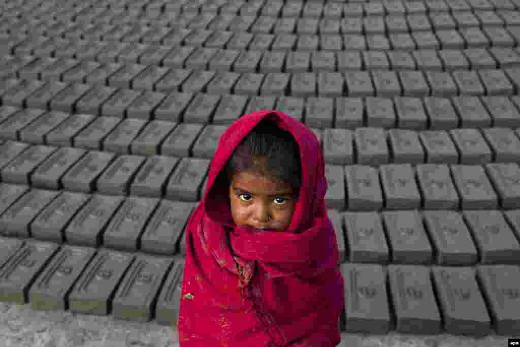 A Nepalese girl, whose parents are workers at a brick factory, in Bhaktapur on December 23. (Hemanta Shrestha/EPA) &nbsp;