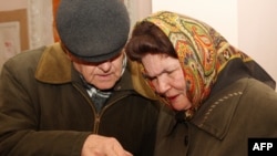 An elderly couple studies the ballot at the westernmost polling station in Ukraine