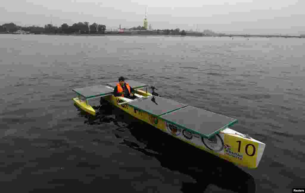 Russian designer Aleksei Maistro on board his electro-solar boat "Amon Ra" in St. Petersburg. The boat is expected to participate in an international competition of solar boats in 2015 in the Russian city. (Reuters/Aleksandr Demianchuk)