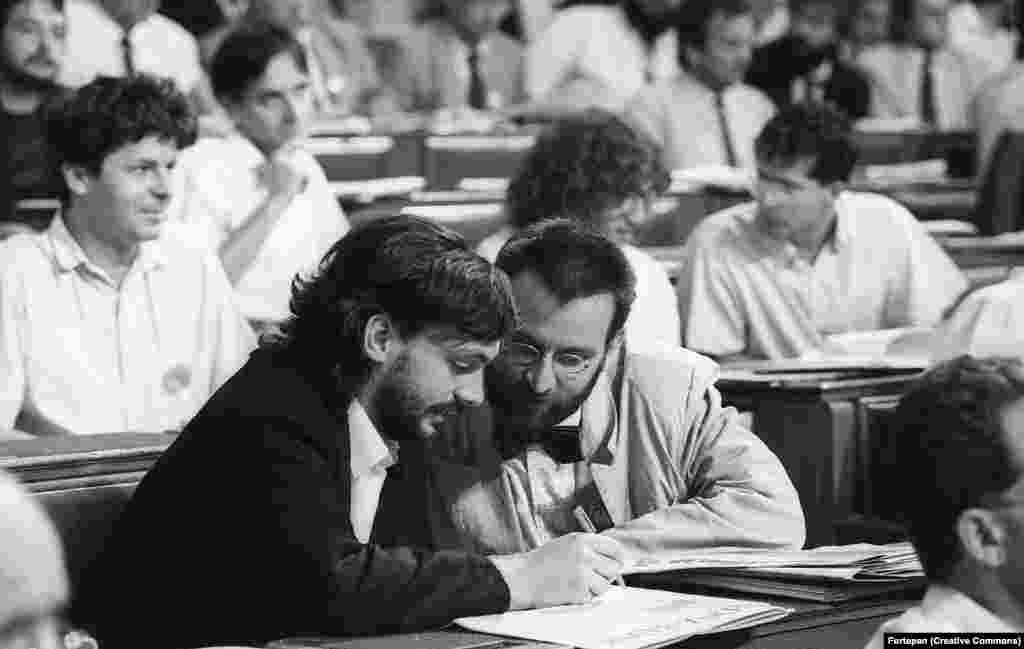 Viktor Orban (left) consults with a colleague in the Hungarian parliament in 1990. The young Orban -- now the country's prime minister -- was known as a fierce critic of Hungary's communist authorities and was photographed being arrested in the late 1980s.