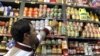 A vendor arranges canned products on a shelf at a grocery store in Tehran on December 19, as the Iranian government began to implement its controversial plan of scrapping subsidies on energy and food products as part of reforms that had been in the pipeli