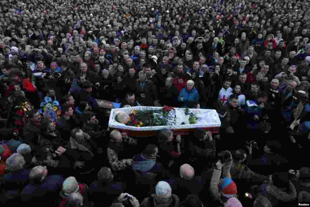 People attend the funeral of an antigovernment protester, who was killed during clashes with riot police in Kyiv, on February 21. (Reuters/Baz Ratner)