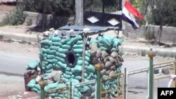 A video grab on April 12 showed a military checkpoint manned by government forces in the Qusur district of the central Syrian city of Homs.