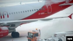 A snowplow clears the runway in Hanover, Germany, on December 19.