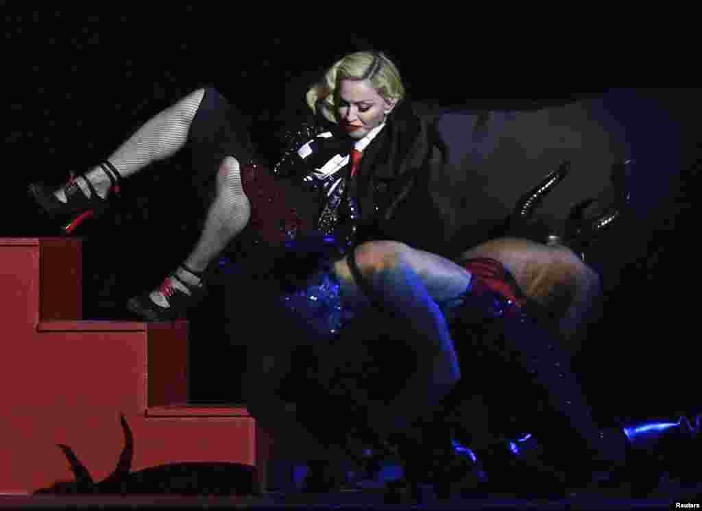 American singer Madonna falls during her performance at the BRIT music awards at O2 Arena in Greenwich, London. (Reuters/Toby Melville)
