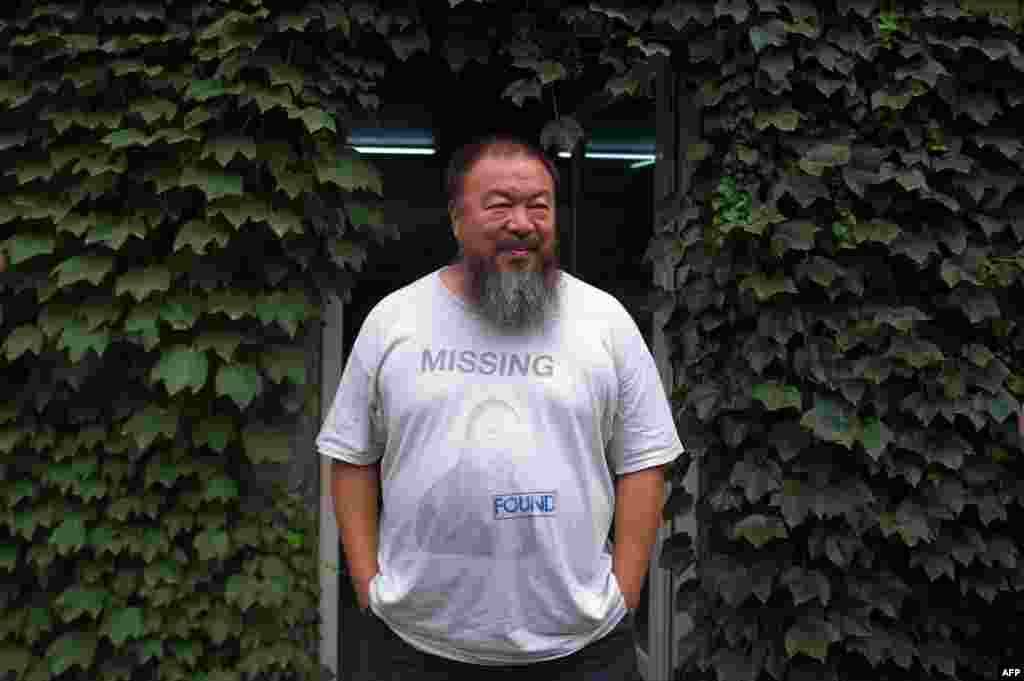 Chinese artist and democracy activist Ai Weiwei waits for his lawyer to return from a court hearing at his compound in Beijing on July 20. The artist lost his appeal against a multi-million-dollar tax fine on a company he founded. (AFP/ Ed Jones)