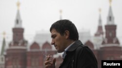 A man smokes on a street in central Moscow