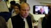 UAE -- Ousted Pakistani Prime Minister Nawaz Sharif gestures as he boards a Lahore-bound flight due for departure, at Abu Dhabi International Airport, uly 13, 2018