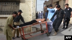 Pakistani policemen carry an injured colleague at a hospital following a bomb explosion in Quetta in September. 