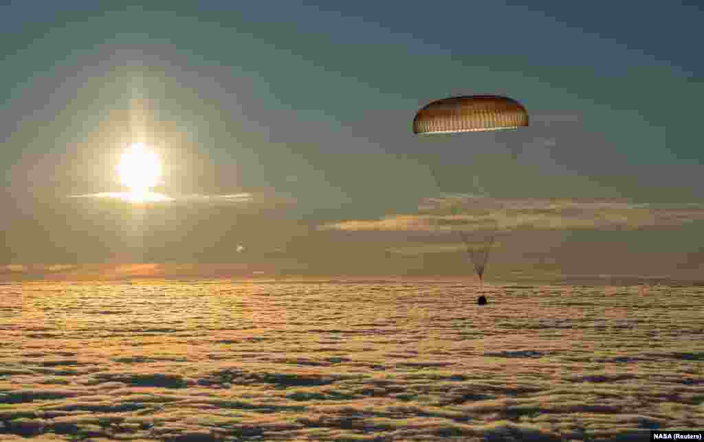 The Soyuz MS-06 capsule carrying the crew of Joe Acaba and Mark Vande Hei of the United States and Alexander Misurkin of Russia descends beneath a parachute just before landing in a remote area in Kazakhstan on February 28. The three International Space Station crew members returned to Earth after a nearly six-month mission.&nbsp;(Reuters/Bill Ingalls/NASA)&nbsp;