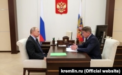 Russian President Vladimir Putin (left) meets on September 26 with Oleg Kozhemyako, who has just been appointed acting governor of the Primorye region.