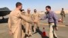 Defense Secretary Mark Esper (right) talks with U.S. troops in front of an F-22 fighter jet deployed to Prince Sultan Air Base in Saudi Arabia on October 22.