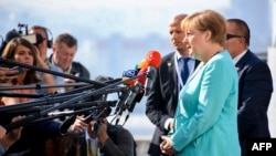German Chancellor Angela Merkel speaks to the media as she arrives for an informal EU summit in Bratislava on September 16. 