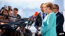 German Chancellor Angela Merkel speaks to the media as she arrives for an informal EU summit in Bratislava on September 16.