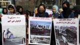 AFGHANISTAN -- Afghan civil society activists hold banners with Dari that reads: from left to right, "We cannot forget the court-martials, Taliban crime in Afghanistan, Taliban group are the factor of destruction and genocide" as they chant slogans agains